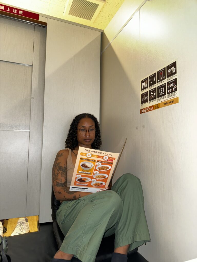 pondering a menu at an internet cafe in japan