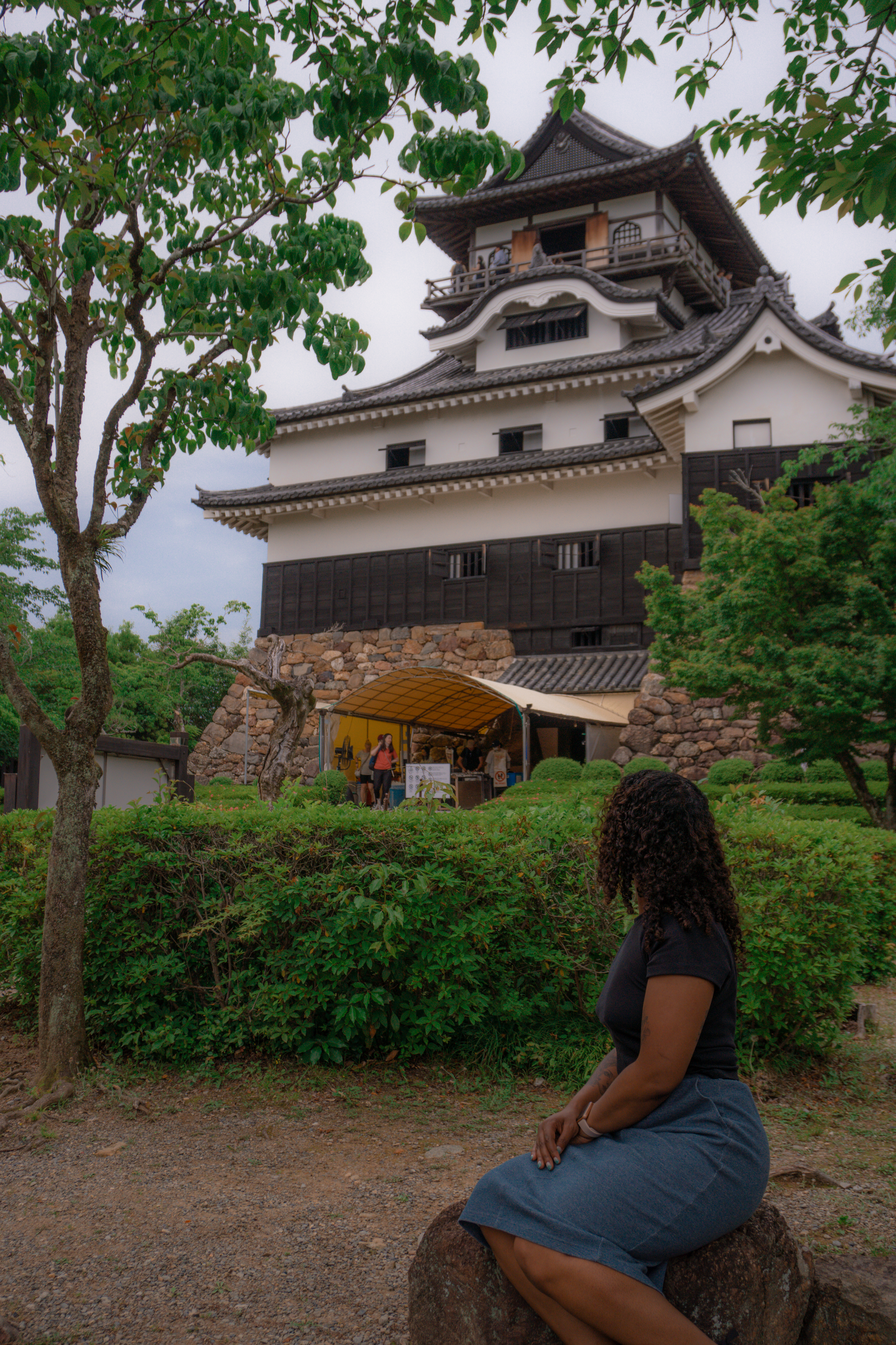 sitting on a rock at Inuyama Castle Japan Travel 犬山城