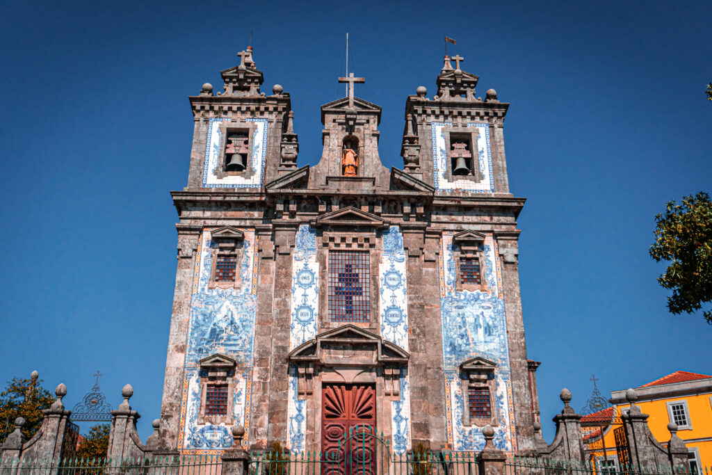 Igreja de Santo Ildefonso church with azulejo facade and city view from hilltop in Porto Portugal