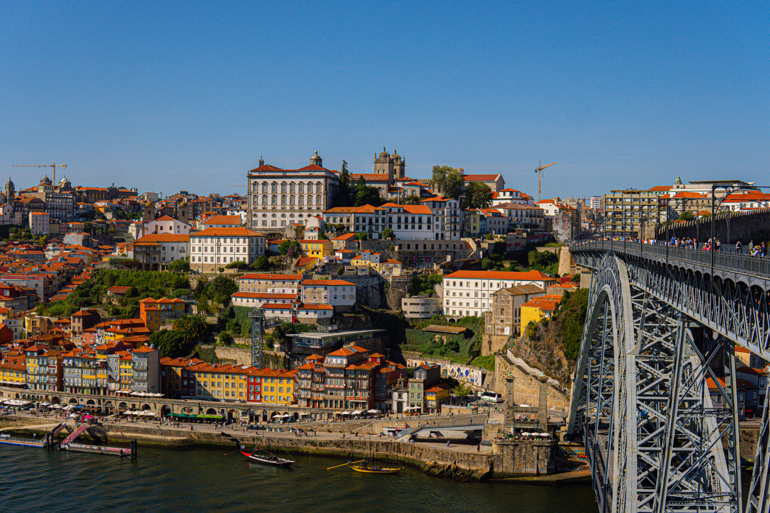 11 Things To Do in Porto: Ribeira district in Porto Portugal with cafes and colorful tiled houses along the Douro River