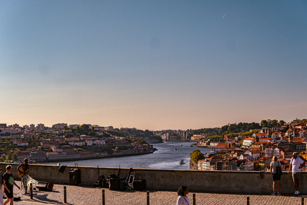 Jardim do Morro park at golden hour overlooking the Douro River and Dom Luís I Bridge in Porto Portugal