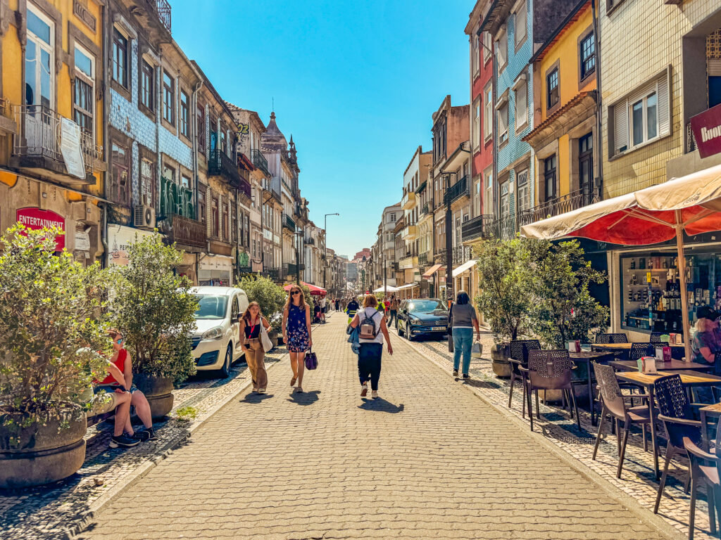 Busy Rua de Santa Catarina shopping street in Porto Portugal with Cafe Majestic and Amorino gelato shop