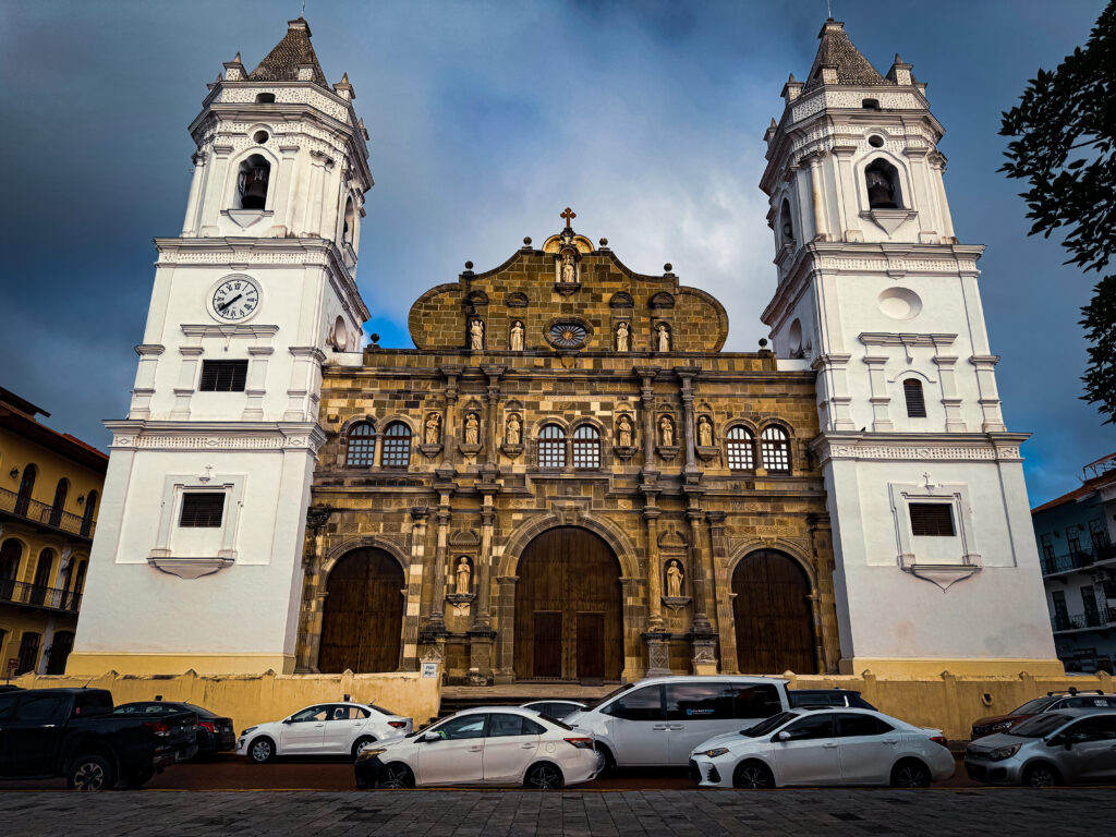 Cathedral Basilica Santa María la Antigua: The white bell towers and stone facade of the Metropolitan Cathedral in Casco Viejo under a blue sky.
