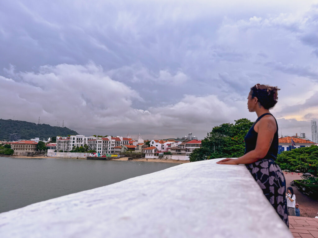 black woman standing at Paseo de las bovedas in panama city