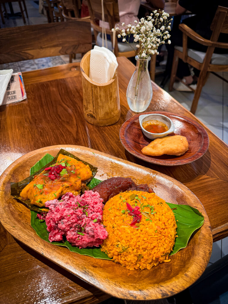 A traditional Panamanian platter with arroz con pollo, platanos, and tamalito at El Nacional restaurant.