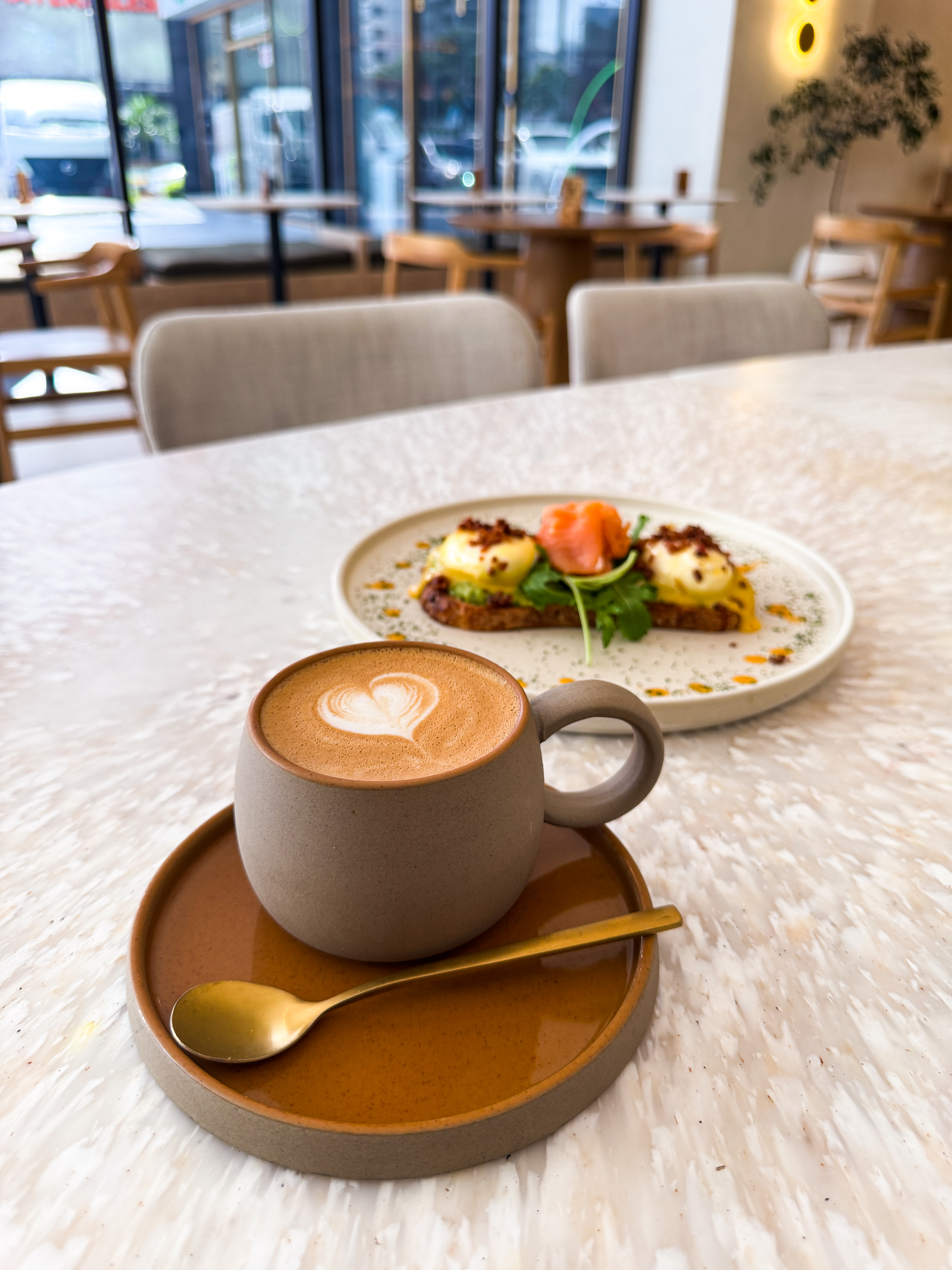 eggs benedict and latter at a minimalist specialty coffee shop interior in the Obarrio district of Panama City, Bungla Coffee
