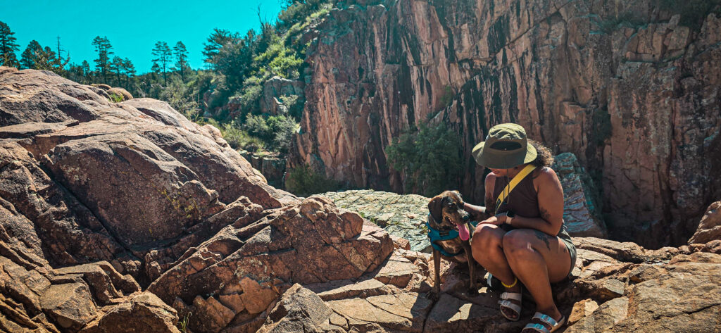 a woman and her soul dog enjoying nature