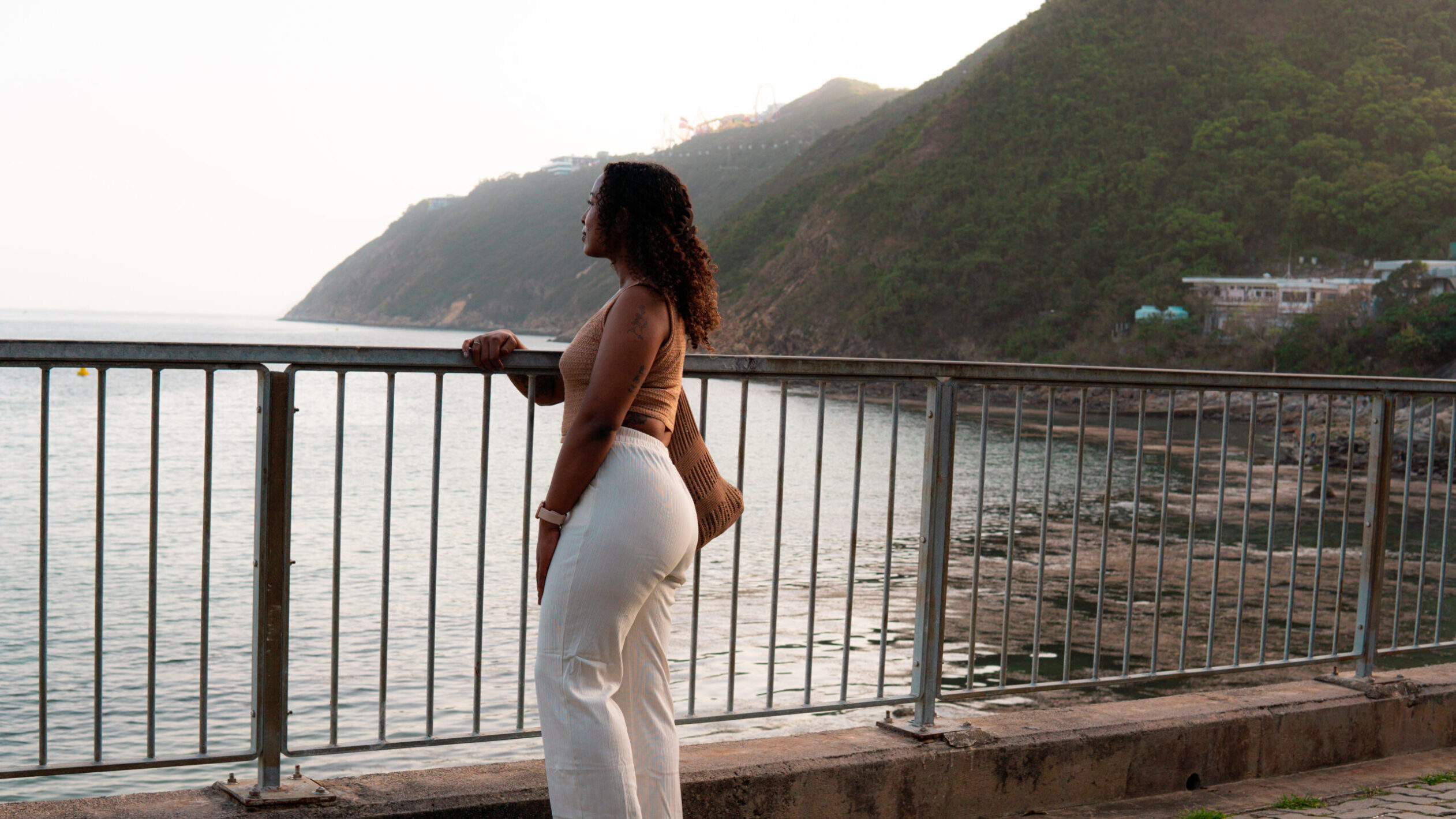 solo female traveler calmly looking out at the water