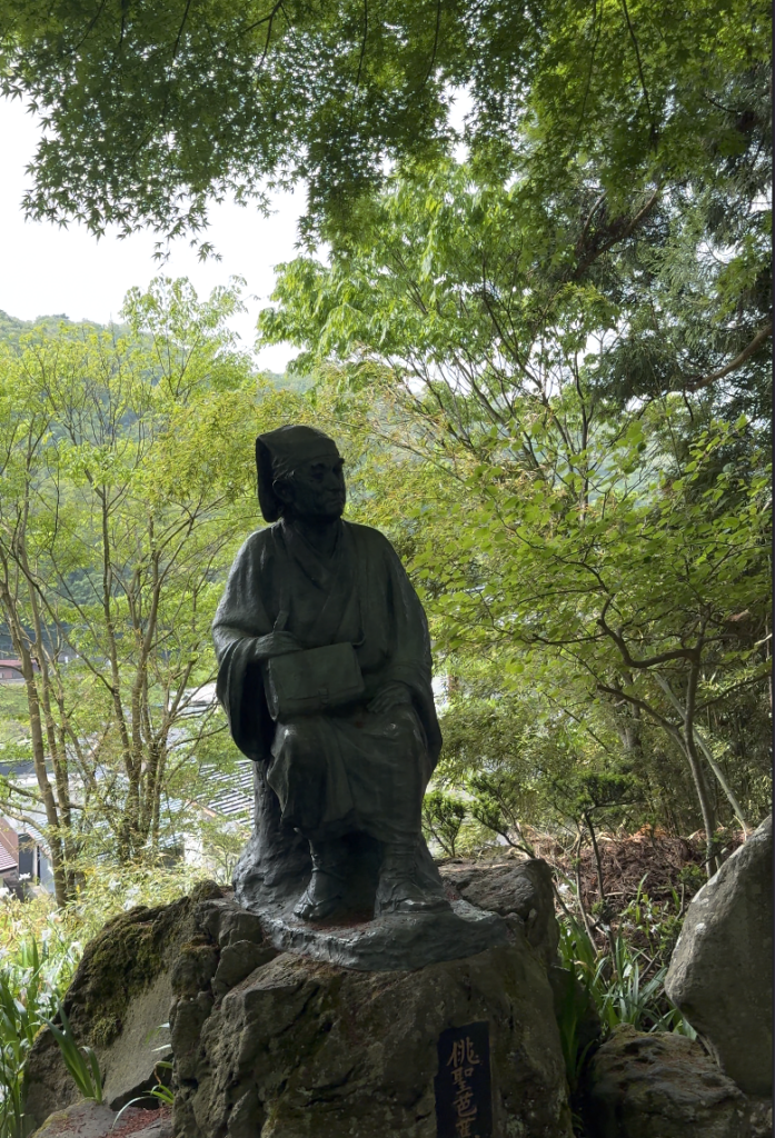 Bronze statue of Edo-period poet Matsuo Basho at the base of the Yamadera mountain trail