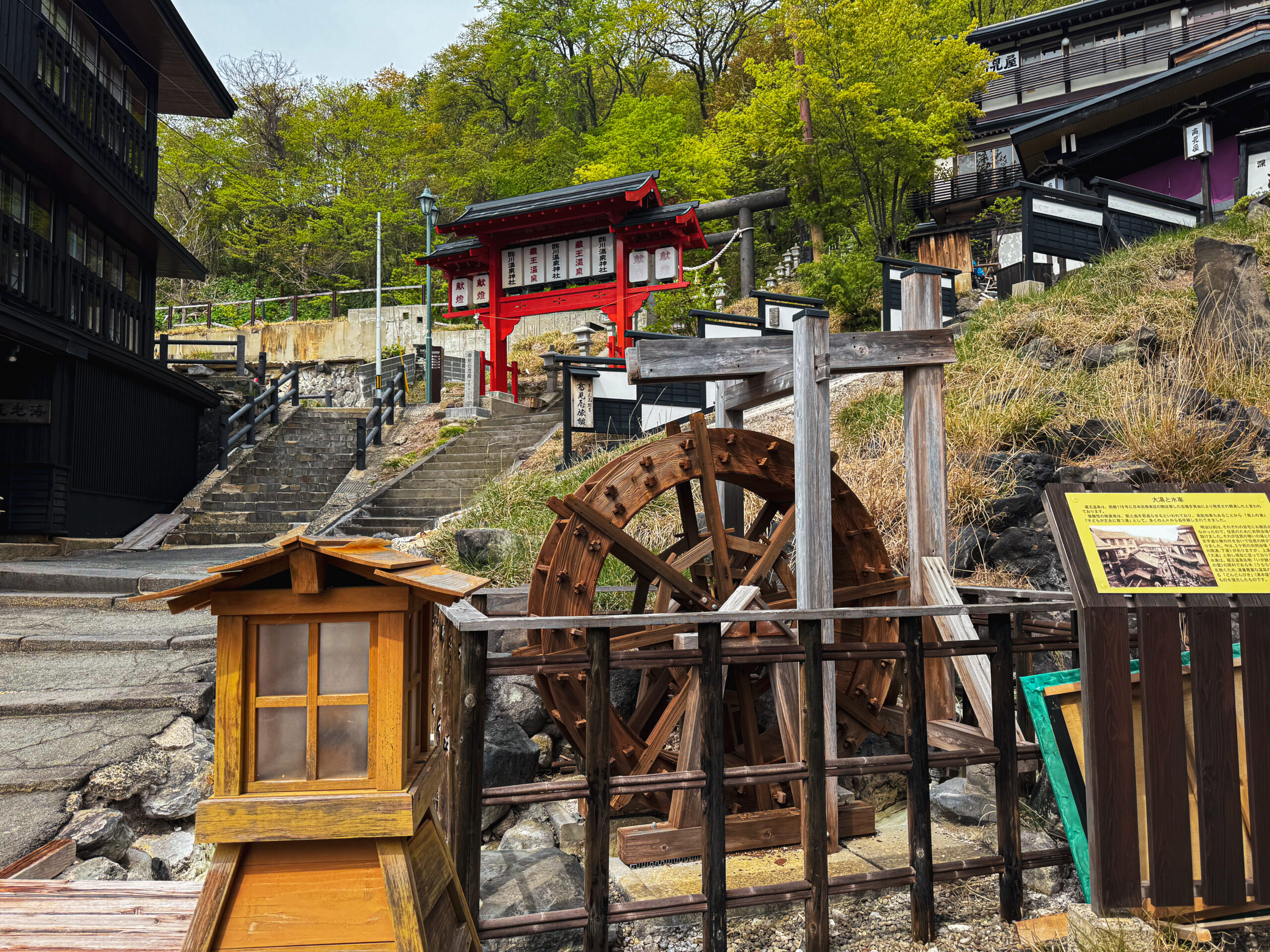 Wooden entrance and stone steps leading up to Sugawa Onsen Shrine in Zao Onsen